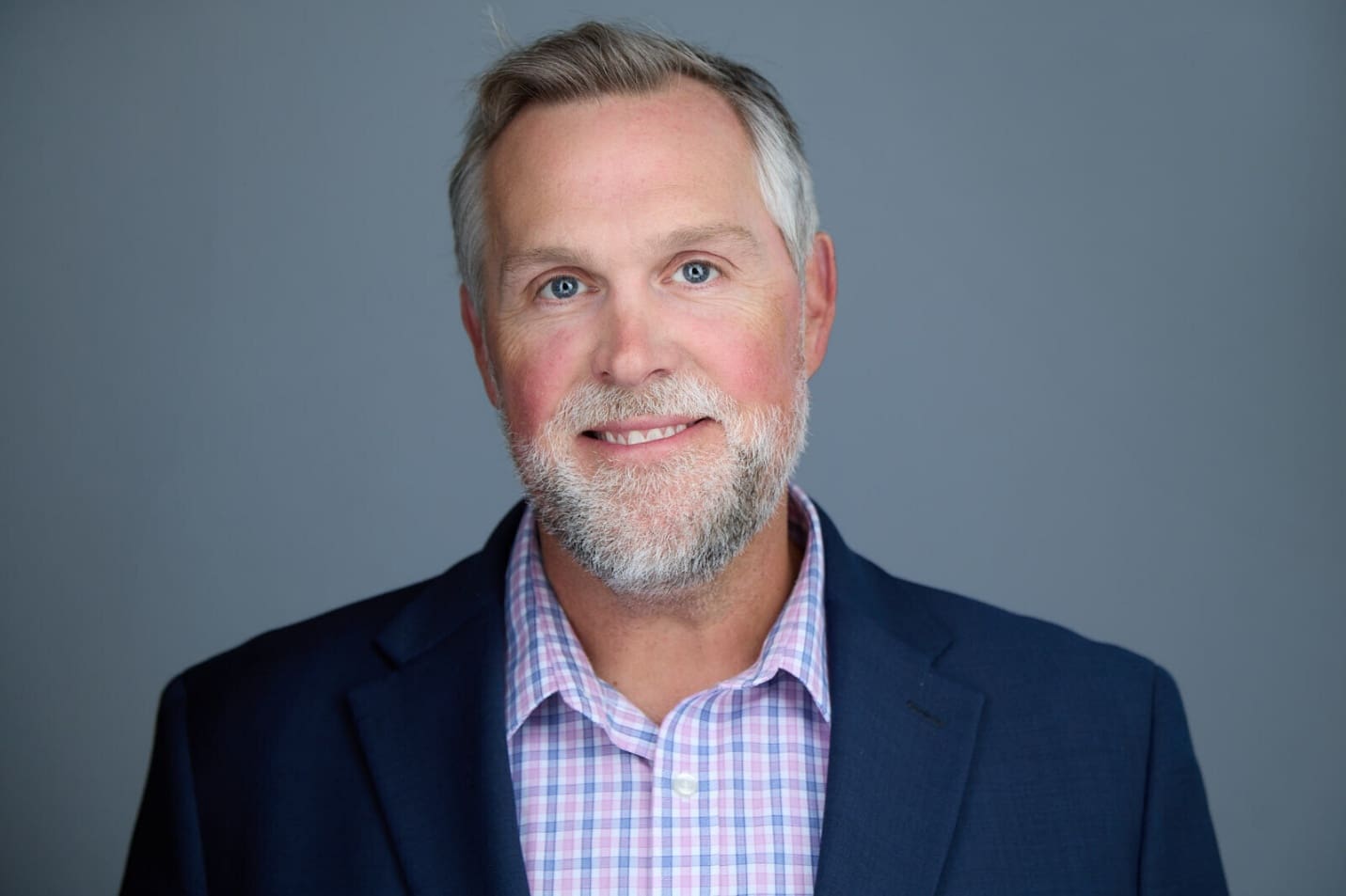 A person in a suit AI-generated content may be incorrect.