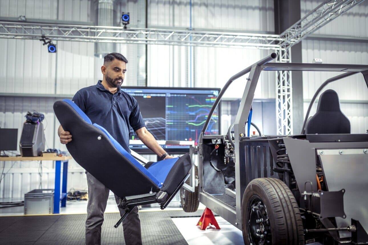 Worker carrying car seat
